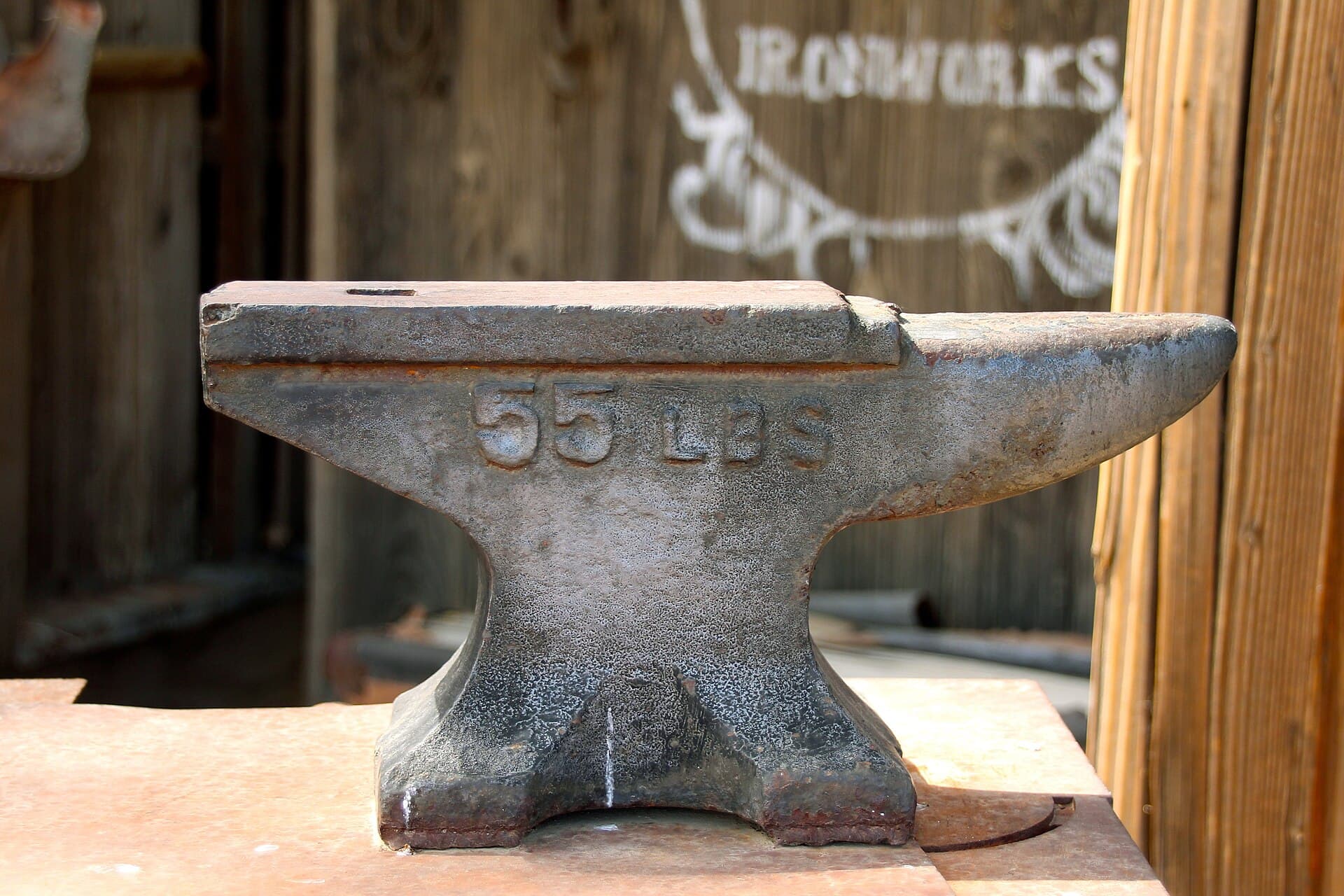 Anvil and iron tools in a working blacksmith shop — what our forge looks like.