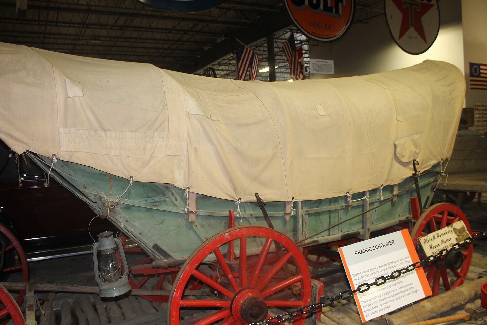 A restored prairie schooner wagon on display.