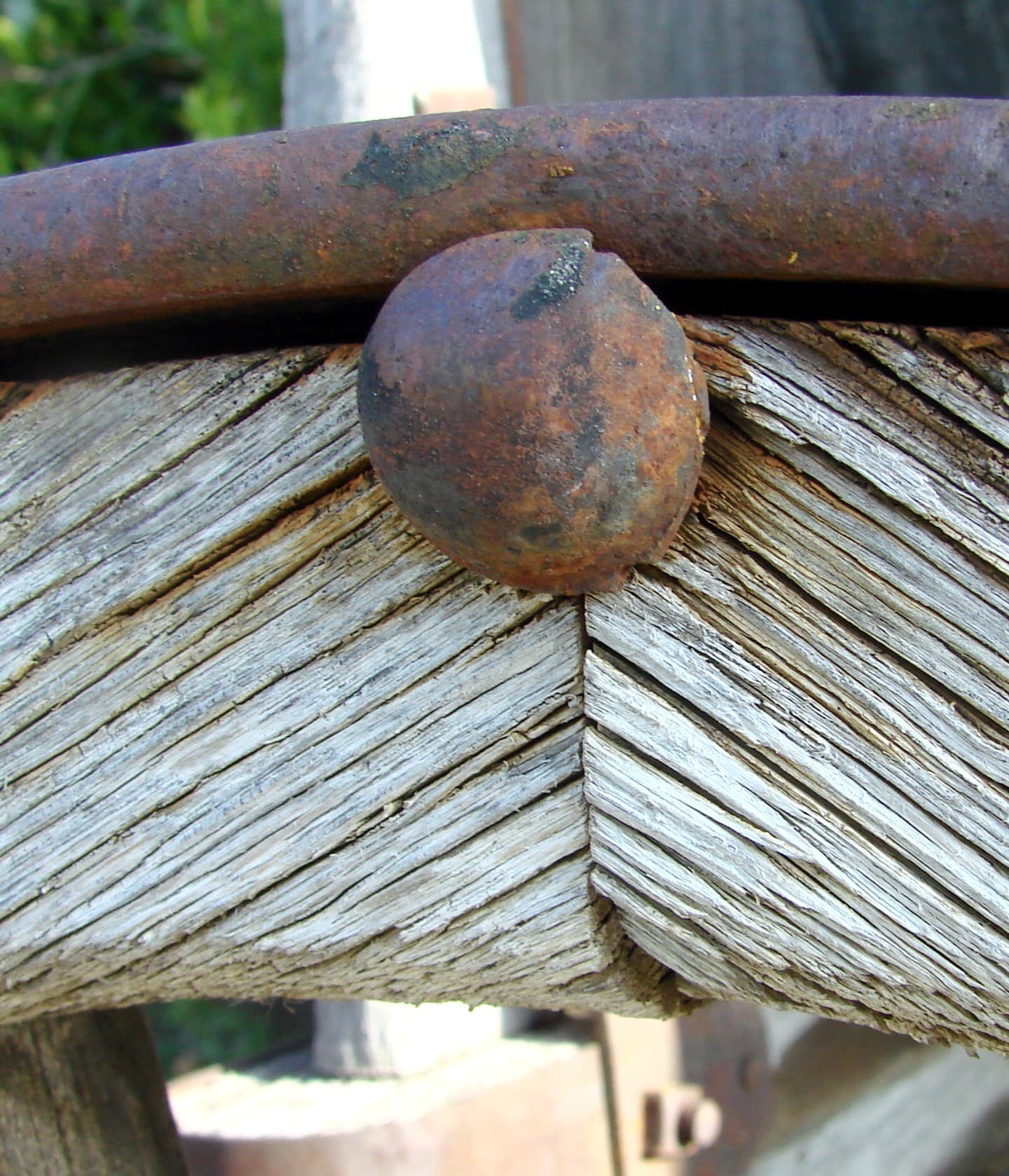 A close-up of a wooden wagon wheel — hub, spokes, and iron tire visible.