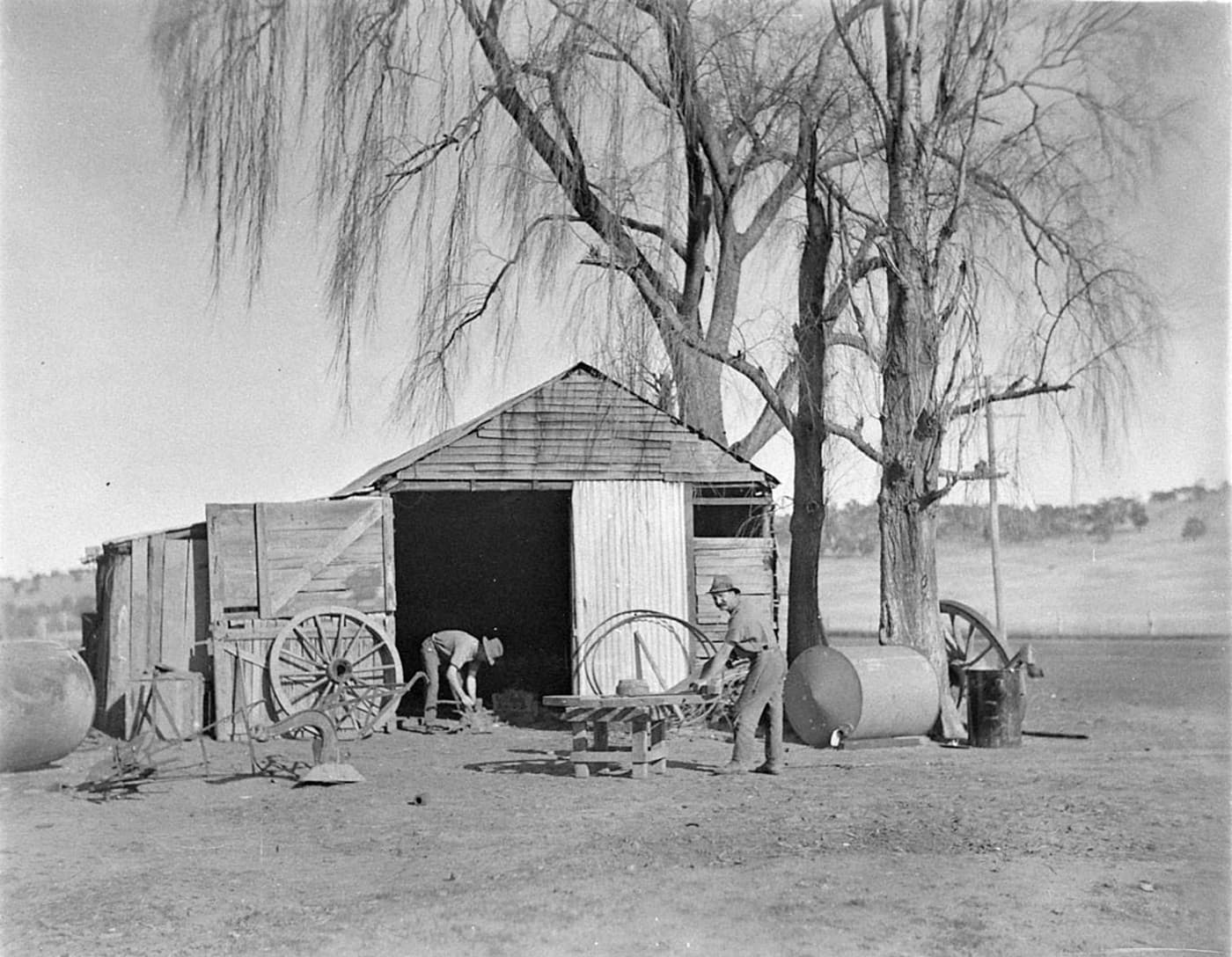 Two wheelwrights working on a wagon wheel at Jindabyne — historical archive photograph.
