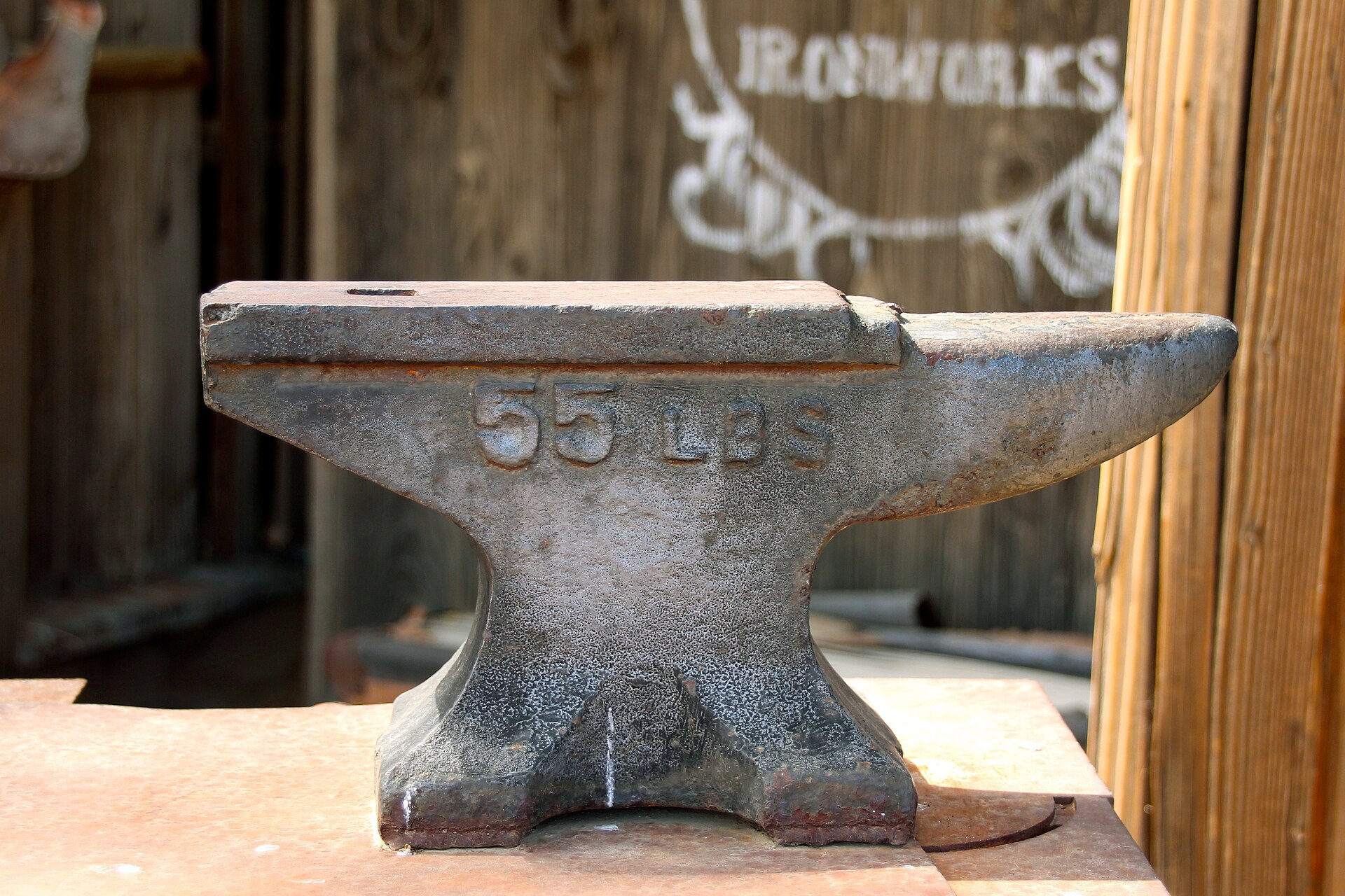 Anvil and iron tools in a working blacksmith shop — what our forge looks like.