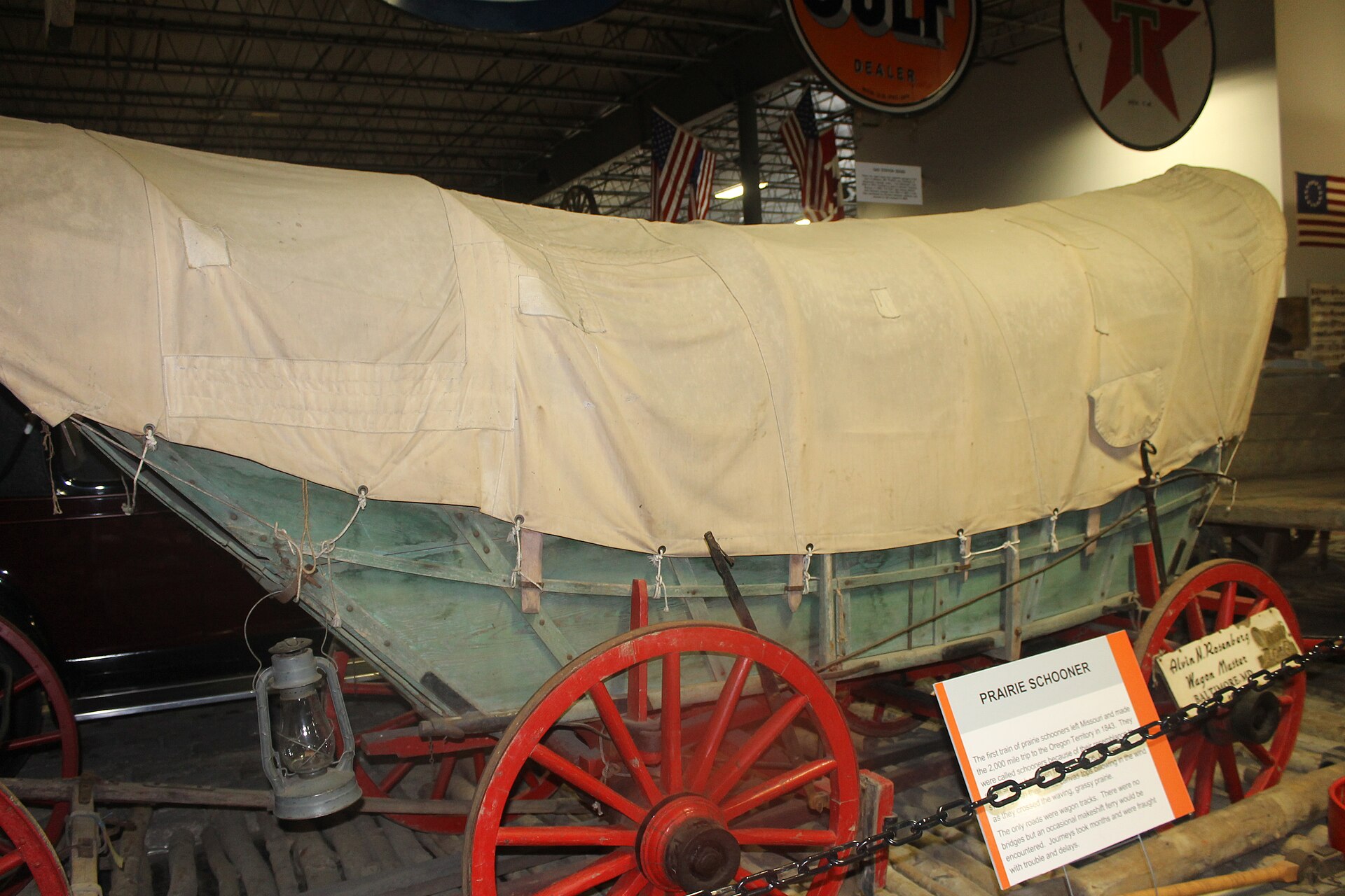 A restored prairie schooner wagon on display.