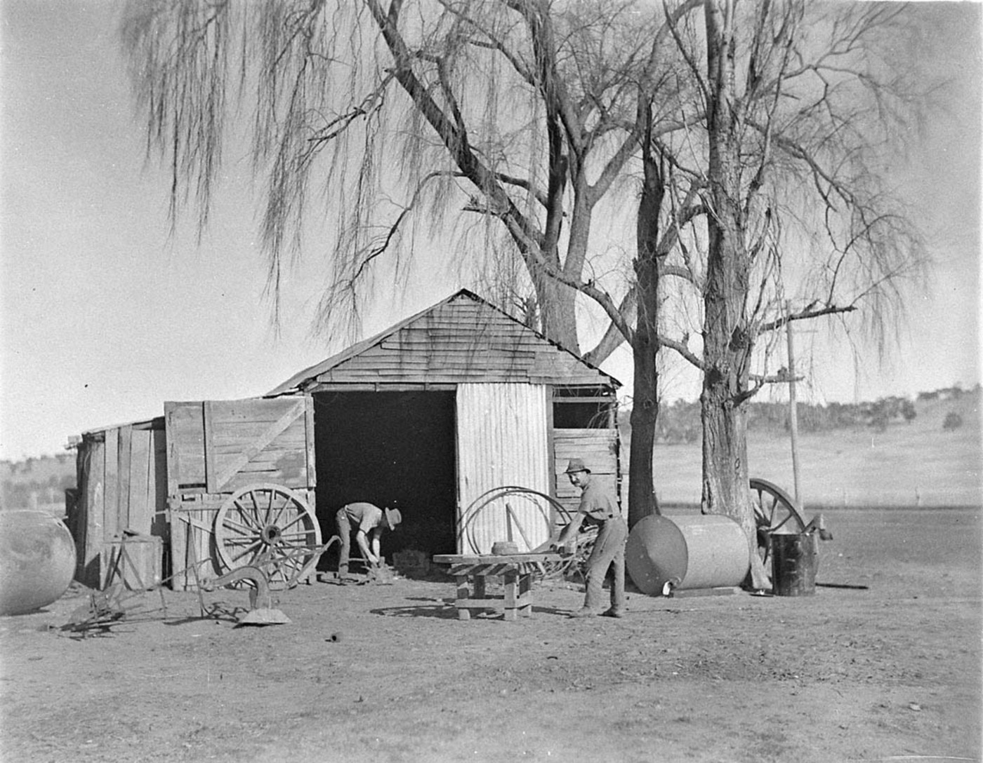Two wheelwrights working on a wagon wheel at Jindabyne — historical archive photograph.